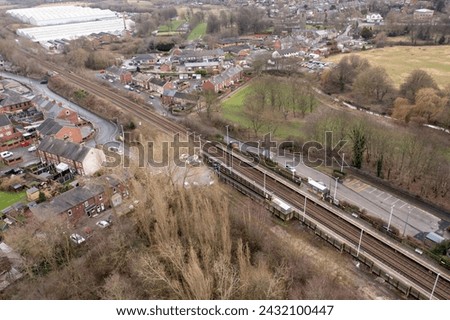 Aerial photo of the town of Darton in Barnsley in Yorkshire UK, showing the town and housing estates next to the train tracks on a cold day in the winter time,