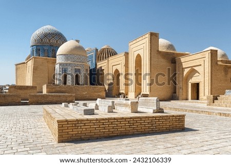 Awesome view of the Shah-i-Zinda Ensemble in Samarkand, Uzbekistan. Mausoleums decorated by blue tiles with designs. The necropolis is a popular tourist attraction of Central Asia. Royalty-Free Stock Photo #2432106339