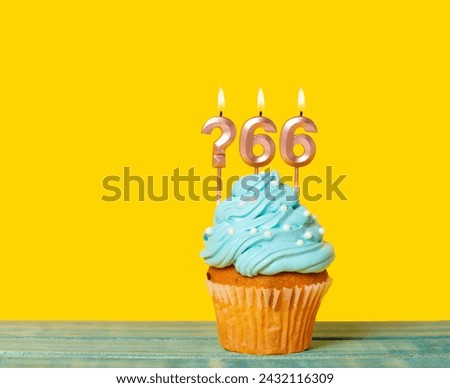 Birthday Cake With Candle Question Mark And Number 66 - On Yellow Background. Royalty-Free Stock Photo #2432116309