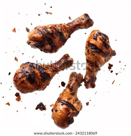 Grilled chicken legs falling in the air isolated on white background.  Royalty-Free Stock Photo #2432118069