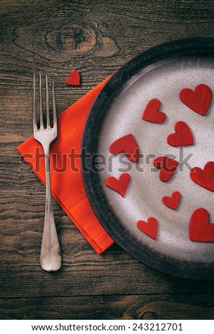 Restaurant series. Valentines day dinner with table setting in rustic wood style with cutlery