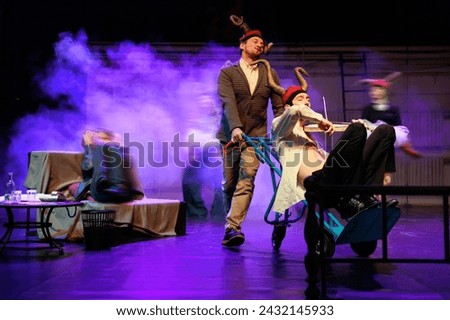 Actors and actresses play a modern performance of the theater stage show Royalty-Free Stock Photo #2432145933