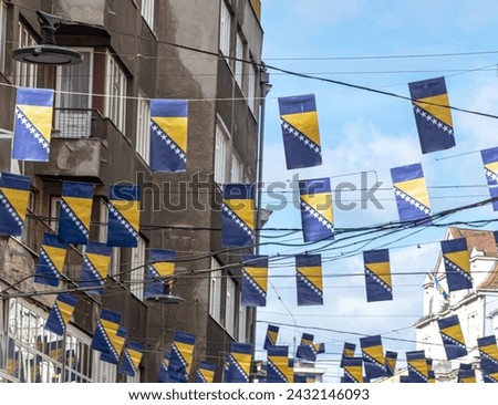 Thousands Bosnian flags on Ferhadija street for Statehood Day Royalty-Free Stock Photo #2432146093