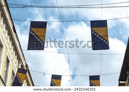 Thousands Bosnian flags on Ferhadija street for Statehood Day Royalty-Free Stock Photo #2432146101