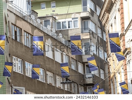 Thousands Bosnian flags on Ferhadija street for Statehood Day Royalty-Free Stock Photo #2432146103