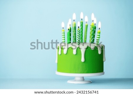 Celebration birthday cake with ten green birthday candles