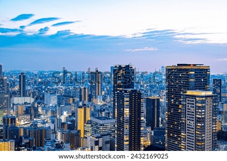 night panorama of Osaka skyline with skyscrapers and crowded streets Royalty-Free Stock Photo #2432169025