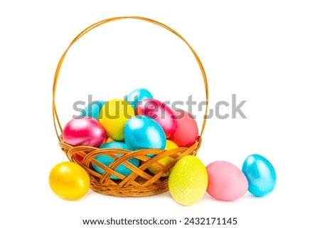 Easter basket filled with colorful eggs isolated on white background. Easter celebration concept. Colorful easter handmade decorated Easter eggs. Royalty-Free Stock Photo #2432171145