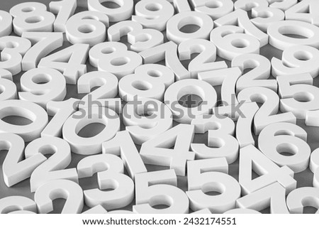 Volumetric white numbers on a gray background. Black and white image.