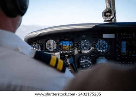 Pilot Operating Small Aircraft Cockpit Instruments Royalty-Free Stock Photo #2432175285