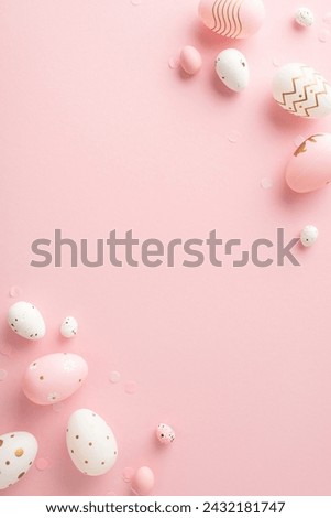 Sophisticated Easter setting vision: vertical top view of dyed eggs, and confetti spread on a pastel pink foundation, intentionally leaving empty space for any greeting text or advertisement purposes Royalty-Free Stock Photo #2432181747