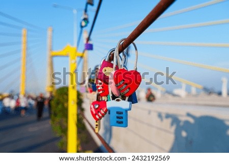 Love locks hanging on parallel bridge to Rama 9 Bridge Chao Phraya River, Thailand's first parallel bridge, Expressway road traffic an important infrastructure in Thailand,