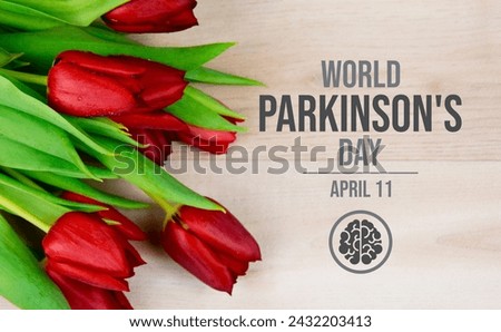 World Parkinson's Day poster with red tulips stock photo images. Red tulip flower on a wooden background photo. Suitable for card, background, banner. April 11 every year. Important day