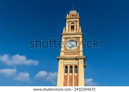 The traditional clock in the Luz station tower, on the terrace of the building that houses the Portuguese language museum, in the city of São Paulo Royalty-Free Stock Photo #2432204631