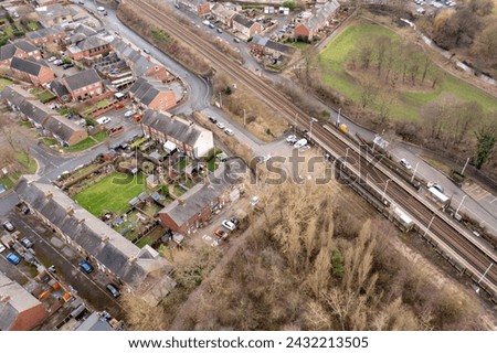 Aerial photo of the town of Darton in Barnsley in Yorkshire UK, showing the town and housing estates next to the train tracks on a cold day in the winter time,