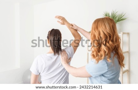 A Modern rehabilitation physiotherapy at work with client Royalty-Free Stock Photo #2432214631