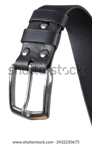 Part of a leather belt with a metal buckle close-up isolated on a white background.