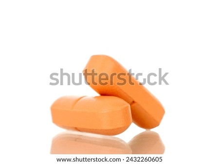 Two medical pills, macro, isolated on white background.