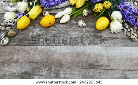 Colorful Easter eggs on wooden background with space for text.