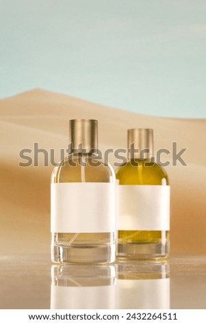 a perfume bottle on a desert background Royalty-Free Stock Photo #2432264511