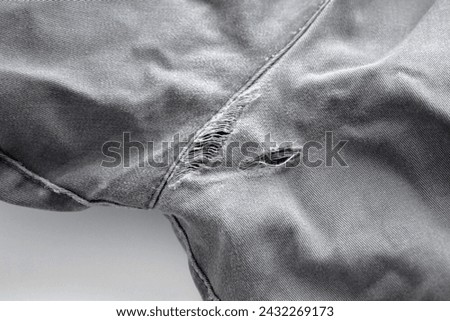 Broken jeans on the back cracked with hole at the crotch. Sewing machine and stitching repair concept. Royalty-Free Stock Photo #2432269173