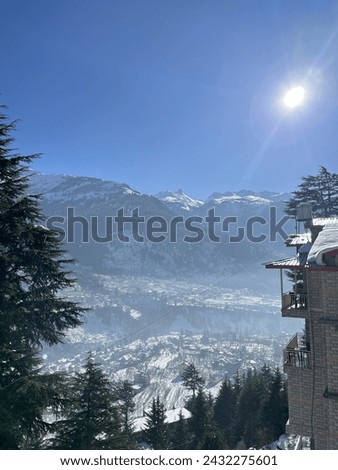 The mountains with this captivating image captured from a ski slope. The picture showcases a panoramic view of majestic peaks, adorned with a dusting of snow, creating a serene and picturesque scene.