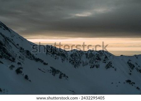 View of the winter sunset and snow-covered mountains. Sochi, Russia