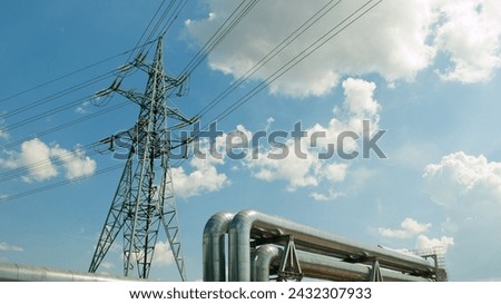 pipeline and power lines against the blue sky.