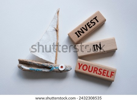 Invest in Yourself symbol. Concept words Invest in Yourself on wooden blocks. Beautiful white background with boat. Business and Invest in Yourself concept. Copy space.