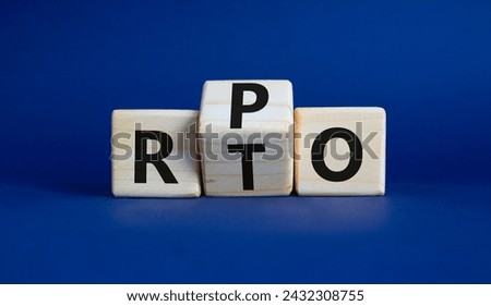 RPO vs RTO symbol. Wooden cubes with words RTO to RPO. Beautiful deep blue background. business concept. Copy space