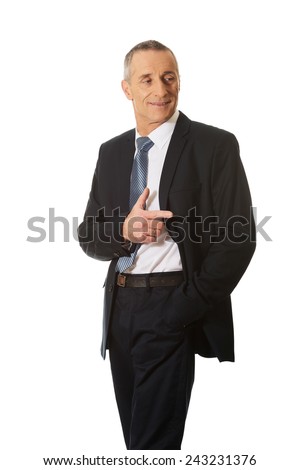 Mature businessman pointing to the right.