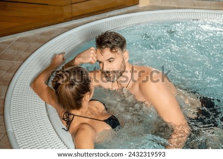 Handsome couple relaxing enjoying hot tub bubble bath on romantic vacation travel holidays or honeymoon