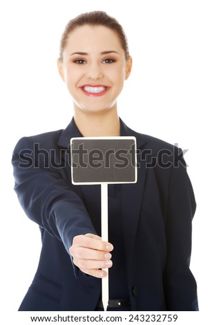 Happy businesswoman holding small empty advertising board
