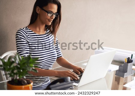 Laptop, planning and business woman at office desk for online project, typing and editing report at creative startup. Worker, writer or editor in glasses on computer for research on an email