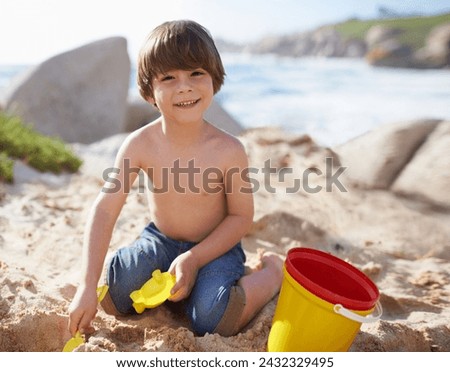 Sand castle, beach and portrait of child with bucket and toys on summer holiday, vacation and relax by ocean. Childhood, building sandcastle and young boy playing for adventure, fun or weekend by sea Royalty-Free Stock Photo #2432329495