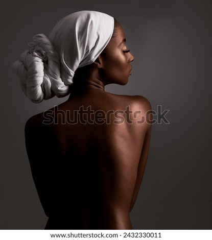 Beauty, body and heritage with natural black woman in studio on gray background for wellness. Skincare, culture or tradition and aesthetic young model in Africa for cosmetics or dermatology from back Royalty-Free Stock Photo #2432330011