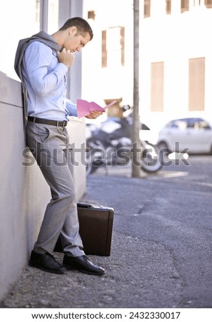 Business, job loss and man on street, fired and reading letter of unemployment on city sidewalk. Anxiety, mental health and sad businessman on road with termination notice, briefcase and pink slip Royalty-Free Stock Photo #2432330017