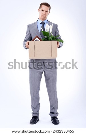 Businessman, suit and box for resignation, fired or transfer at company for liquidation on white backdrop. Employee, worker and sad person for organization loss, fraud and turnover with memorabilia Royalty-Free Stock Photo #2432330455