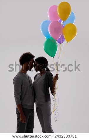 Couple, silhouette and love with party balloons for celebration, event or romance on a gray studio background. Man and woman with colorful blowups of helium for date or anniversary on mockup space