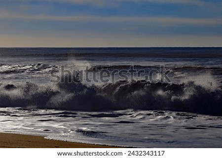Cabedelo, Portugal - January 11, 2024: The waves of the Atlantic Ocean crashing at the beach near Viana do Castelo, polpular destination for surfing sports