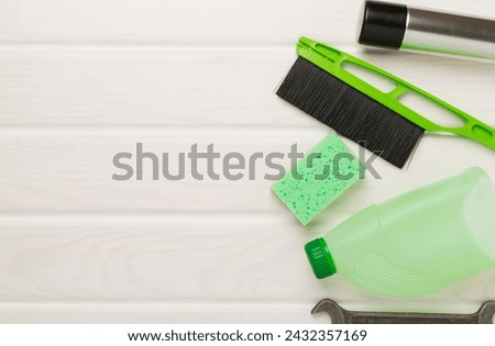 Car tools and accessories on wooden background, top view