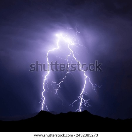 A magnificent electric spark discharge of lightning with thunderclaps in the night sky Royalty-Free Stock Photo #2432383273