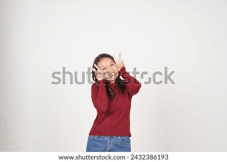 Young Asian woman in Red t-shirt smiling and showing peace or victory sign showing  isolated on white background
