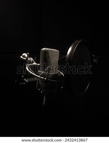 Isolated image of a microphone with plain black background