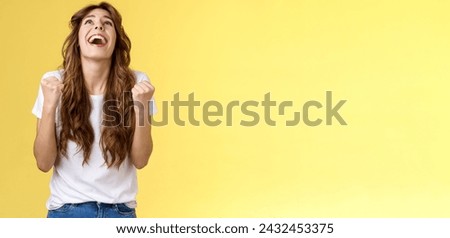 God finally yes. Relieved thankful pleased happy girl look up thank god fist pump celebration success win triumphing clench arms grateful delighted lucky opportunity stand yellow background. Royalty-Free Stock Photo #2432453375