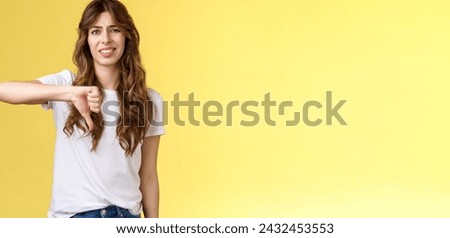 So lame you loser. Ignorant snobbish good-looking woman give own judgement negative opinion disagree grimacing cringe dislike show thumb down disappointed unimpressed yellow background. Royalty-Free Stock Photo #2432453553