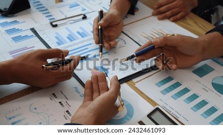 Close up of hands of business people working together in a conference room, brainstorming, discussing and analyzing and planning business strategies.