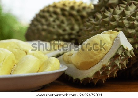 Durian is a king of fruit in Thailand and asia fruit have a spikes shell and sweet can buy at Thai street food and fruit market at agriculture farm Royalty-Free Stock Photo #2432479001