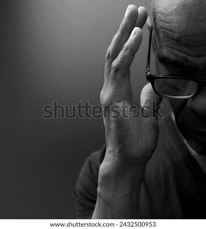 man praying to god Caribbean man praying with people stock image stock photo	