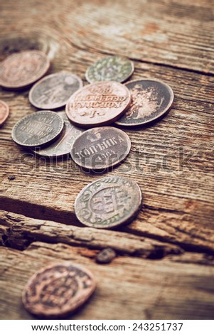 Old coins on wooden background